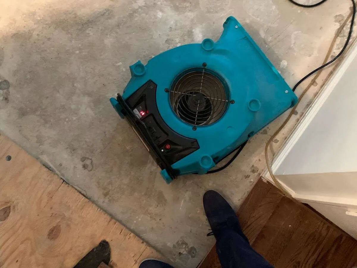 Air mover drying subfloor during Commercial Water Damage Restoration in Sellersburg